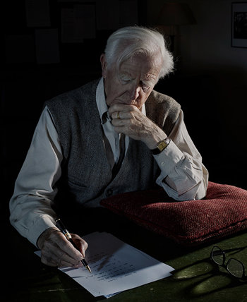 John Le Carré writing at his desk