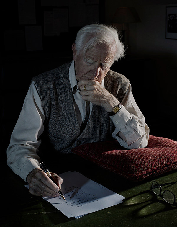 John Le Carré writing at his desk