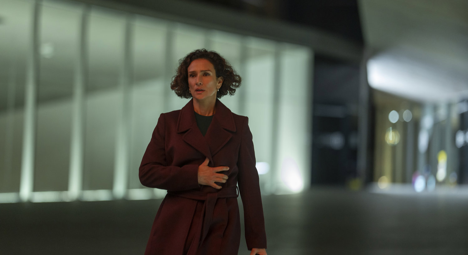 Woman in burgundy coat carrying briefcase 